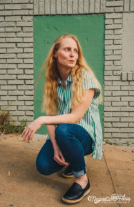 Lost but making good time: Girl in front of Brick Building 